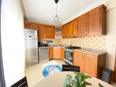 a kitchen with wooden cabinets and stainless steel appliances at City Center Spacious Flat No9 in Istanbul