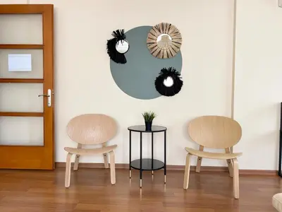 two chairs and a table in a room with a mirror at City Center Spacious Flat No9 in Istanbul