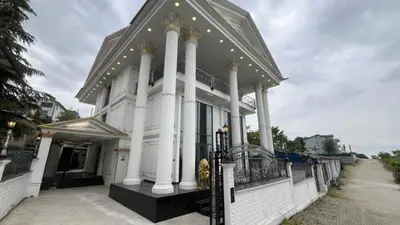 a large white building with columns and a balcony at Luxury Skylights Villa in Kullar