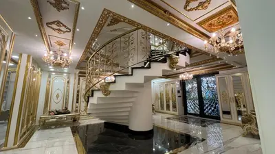 a hallway with a staircase with chandeliers at Luxury Skylights Villa in Kullar