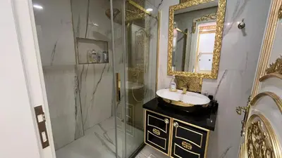 a bathroom with a shower and a sink and a mirror at Luxury Skylights Villa in Kullar