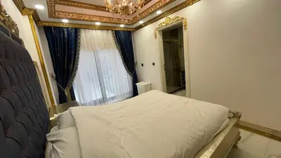 a bedroom with a bed with a chandelier and a window at Luxury Skylights Villa in Kullar