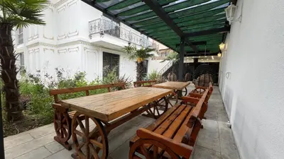 a wooden table and benches on a patio at Luxury Skylights Villa in Kullar
