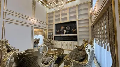 a living room with chairs and a tv and a chandelier at Luxury Skylights Villa in Kullar