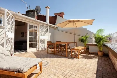 a patio with a table and chairs and an umbrella at Roof top, close to Taksim, with private terrace in Istanbul
