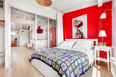 a bedroom with a red accent wall and a bed at Roof top, close to Taksim, with private terrace in Istanbul