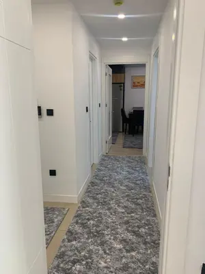 a hallway of a home with white walls and a carpet at Luxury Rezidans in Istanbul