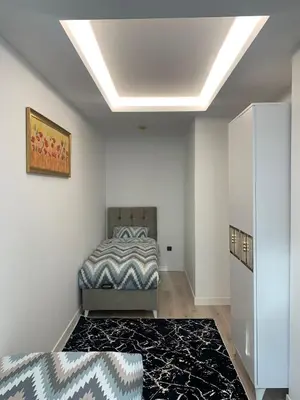 a bedroom with a bed and a rug at Luxury Rezidans in Istanbul