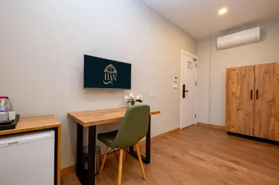 a room with a desk and a green chair at The Han YK Hotel in Avcılar