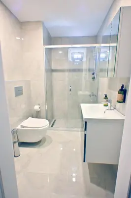 a bathroom with a shower and a toilet and a sink at The Han YK Hotel in Avcılar