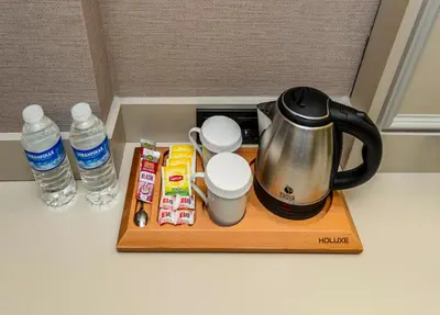a coffee pot on a tray next to two bottles of water at Felix Hotel in Istanbul