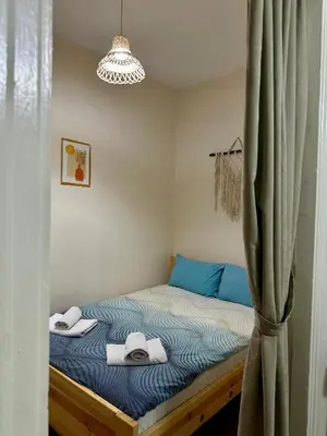 a bedroom with a bed with towels on it at Hostel Nelly in Istanbul