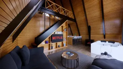 an attic room with a couch and a table at Redka Bungalov Resort in Ulupelit