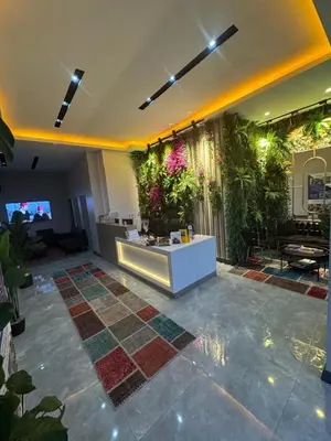 a living room with a lobby with plants at Fourpoints Airport Hotel in Arnavutköy