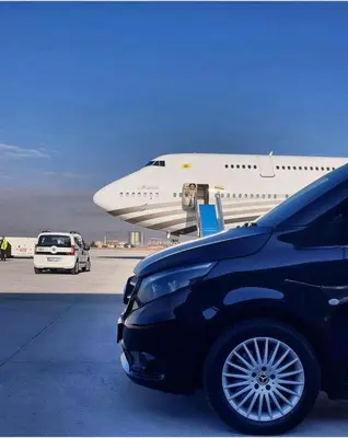 an airplane parked in a parking lot next to a car at Fourpoints Airport Hotel in Arnavutköy