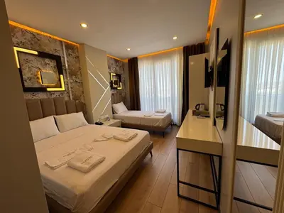 a hotel room with two beds and a bathroom at Fourpoints Airport Hotel in Arnavutköy