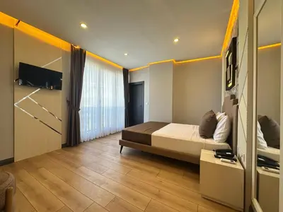 a bedroom with a bed and a tv on the wall at Fourpoints Airport Hotel in Arnavutköy