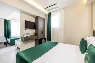 a hotel room with a bed and a television at Sistina Old City Hotel in Istanbul