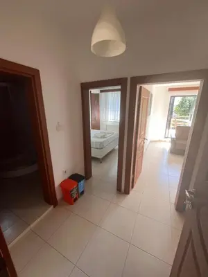 a living room with doors and a room with a couch at Enn Is Inn Hotel in Marmaraereglisi
