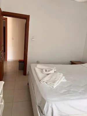 a bedroom with a bed with white towels on it at Enn Is Inn Hotel in Marmaraereglisi