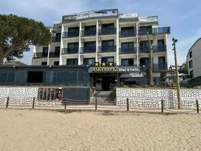a hotel on the beach in front of a building at Kerpe Askoroz Otel in Kandıra