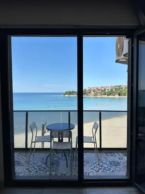 a table and chairs on a balcony with a view of the beach at Kerpe Askoroz Otel in Kandıra
