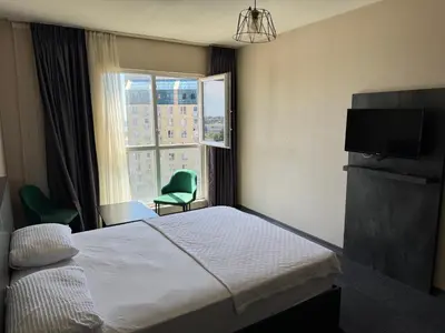 a hotel room with a bed and a window at Pin Suite in Buyukcekmece
