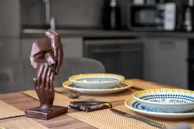 a wooden head sitting on top of a table with plates at Boho-Chic 1BR in Firuzaga - Near Galata in Istanbul