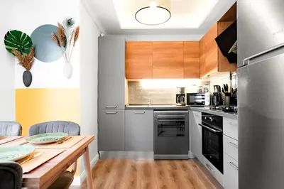 a kitchen with a wooden table and a dining room at Forest Inspired Designed 1BR Luxury Flat In Tomtom in Istanbul