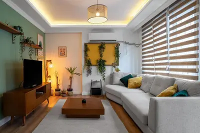 a living room with a couch and a tv at Forest Inspired Designed 1BR Luxury Flat In Tomtom in Istanbul