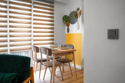 a dining room with a wooden table and chairs at Forest Inspired Designed 1BR Luxury Flat In Tomtom in Istanbul