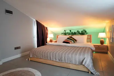 a bedroom with a large bed in a room at Luxury 1BR Duplex with Terrace & Office in Tomtom in Istanbul