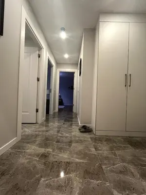 an empty hallway with white cabinets and tile floors at Istanbul Bostanci Family Modern Residence with Pool in Istanbul