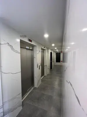 a hallway of an office with white walls and a elevator at Istanbul Bostanci Family Modern Residence with Pool in Istanbul