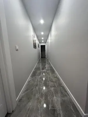 an empty hallway with white walls and a marble floor at Istanbul Bostanci Family Modern Residence with Pool in Istanbul