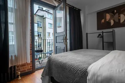 a bedroom with a bed and a view of a balcony at Designed 2BR Rooftop Duplex with Private Terrace in Istanbul