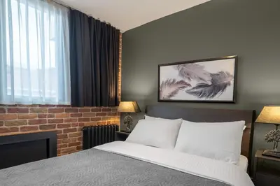 a bedroom with a bed and a brick wall at Designed 2BR Rooftop Duplex with Private Terrace in Istanbul