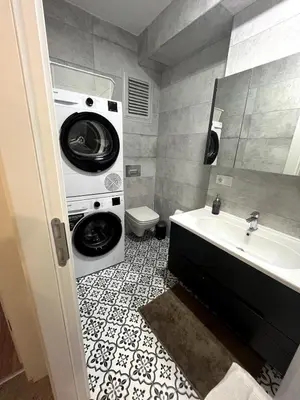 a bathroom with a washing machine and a sink at Köylüm Bostanci Residence-3 in Istanbul