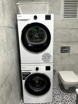 a washer and dryer in a bathroom with a toilet at Köylüm Bostanci Residence-3 in Istanbul