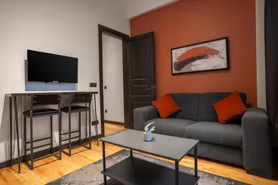 a living room with a couch and a table at Charming 1BR Flat with Balcony in Cihangir in Istanbul