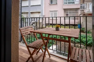 a wooden table and two chairs on a balcony at Charming 1BR Flat with Balcony in Cihangir in Istanbul