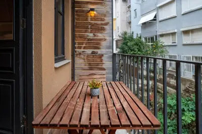 a wooden table with a potted plant sitting on a balcony at Charming 1BR Flat with Balcony in Cihangir in Istanbul