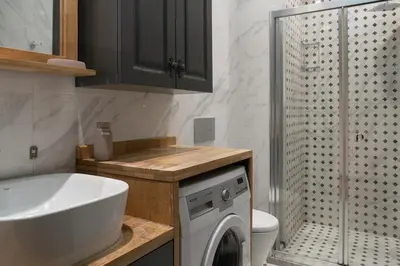 a bathroom with a sink and a washing machine at Cozy Urban 1BR Nest with Balcony Charm in Istanbul