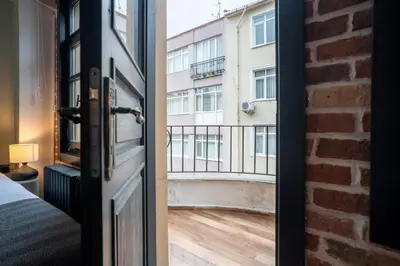 an open door with a view of a building at Cozy Urban 1BR Nest with Balcony Charm in Istanbul