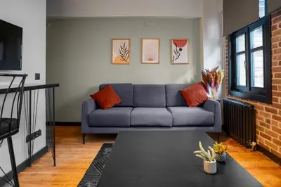a living room with a couch and a table at Cozy Urban 1BR Nest with Balcony Charm in Istanbul
