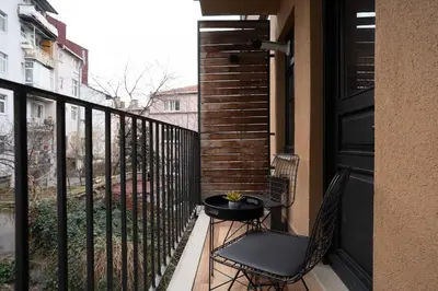 a balcony with two chairs and a table on it at Cozy Urban 1BR Nest with Balcony Charm in Istanbul