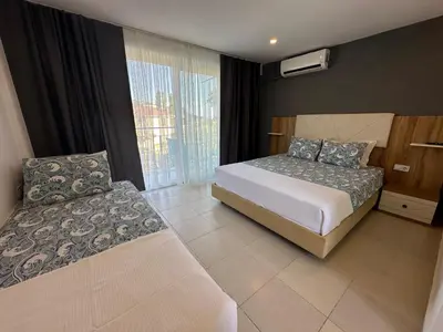 a hotel room with two beds and a window at ADASU Otel in Marmara
