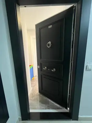 a black door with a mirror in a hallway at Suadiye Bostanci Luxury 2 Bedroom Apartment with Pool in Istanbul