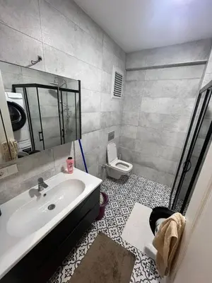 a bathroom with a sink and a toilet at Suadiye Bostanci Luxury 2 Bedroom Apartment with Pool in Istanbul
