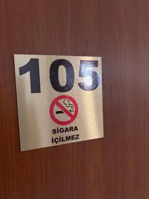 a sign on a door with a sign on it at Ennis İnn Resort Hotel in Marmaraereglisi